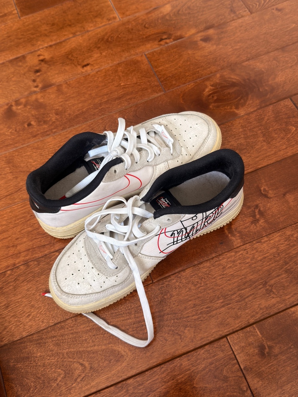 Nike Kids White Sneakers with Black Collar and Red Swoosh
